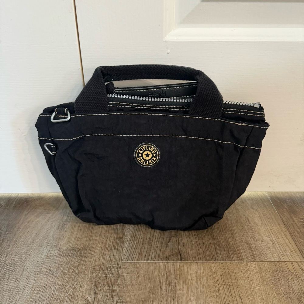 Kipling Black Mini Bag with Crossbody Strap and Zipper Closure